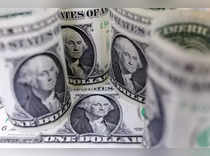 Dollar holds gains on reassuring data, euro slips