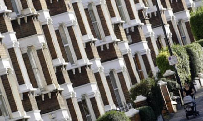 A row of red-brick Victorian terrace houses in south London.