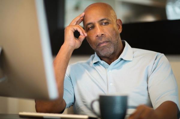 A man thinking while being angry and staring off into the distance